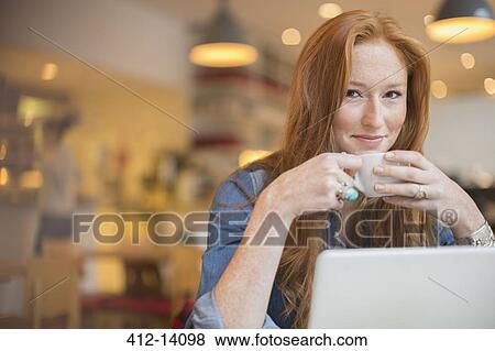 Woman using laptop in cafe View Large Photo Image Stock Photo - Woman using laptop in cafe. Fotosearch
