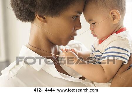 Baby boy playing with mother's necklace View Large Photo Image Picture - Baby boy playing with mother's necklace. Fotosearch