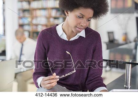 Businesswoman reading at table View Large Photo Image Stock Photograph - Businesswoman reading at table. Fotosearch