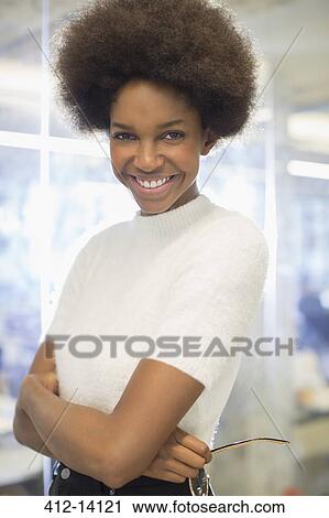 Businesswoman smiling in office View Large Photo Image Stock Image - Businesswoman smiling in office. Fotosearch