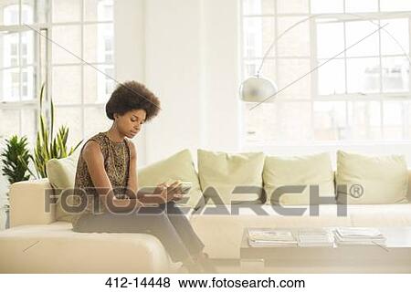 Businesswoman using digital tablet on sofa View Large Photo Image Stock Photo - Businesswoman using digital tablet on sofa. Fotosearch