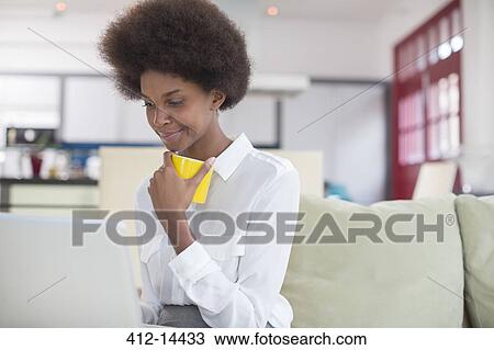 Businesswoman using laptop at breakfast View Large Photo Image Stock Image - Businesswoman using laptop at breakfast. Fotosearch