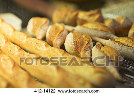 Stock Image - Close up of fresh bread in bakery. Fotosearch