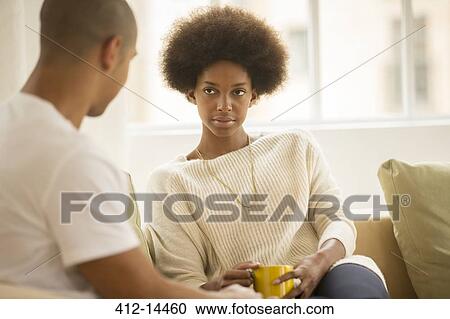 Couple drinking coffee on sofa View Large Photo Image Stock Image - Couple drinking coffee on sofa. Fotosearch