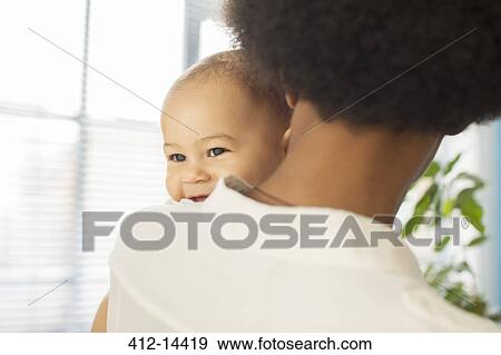 Stock Photo - Mother carrying baby boy. Fotosearch