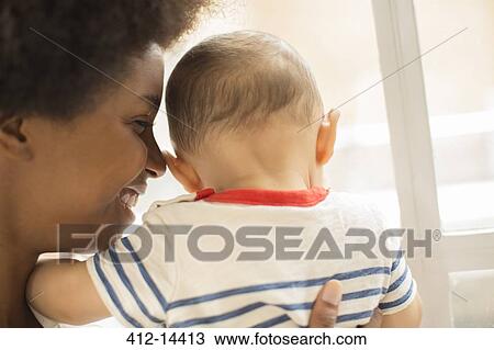Stock Image - Mother holding baby boy. Fotosearch