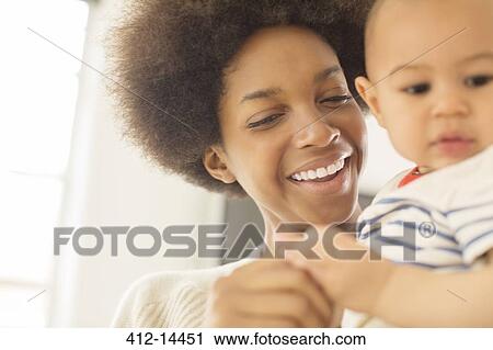 Stock Image - Mother holding baby boy. Fotosearch