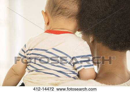 Stock Image - Mother holding baby boy. Fotosearch
