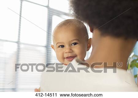 Stock Image - Mother holding baby boy. Fotosearch