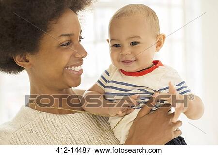 Stock Photo - Mother holding baby boy. Fotosearch