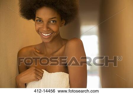 Smiling woman wrapped in towel View Large Photo Image Stock Photograph - Smiling woman wrapped in towel. Fotosearch
