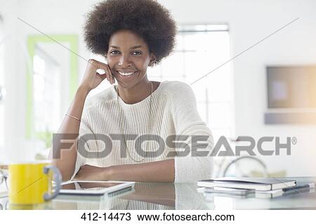 Woman using digital tablet at desk View Large Photo Image Stock Image - Woman using digital tablet at desk. Fotosearch