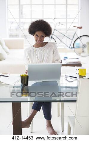 Woman using laptop at desk View Large Photo Image Stock Image - Woman using laptop at desk. Fotosearch