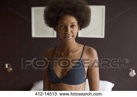 Woman wearing bra in bedroom View Large Photo Image Stock Image - Woman wearing bra in bedroom. Fotosearch