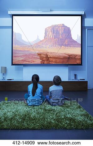 Stock Photo - Children watching television in living room. Fotosearch
