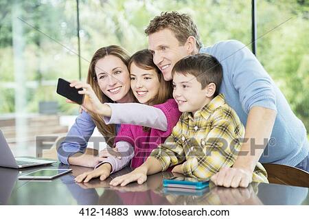 Family taking cell phone picture together View Large Photo Image Stock Image - Family taking cell phone picture together. Fotosearch