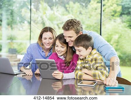 Family using digital tablet together View Large Photo Image Picture - Family using digital tablet together. Fotosearch