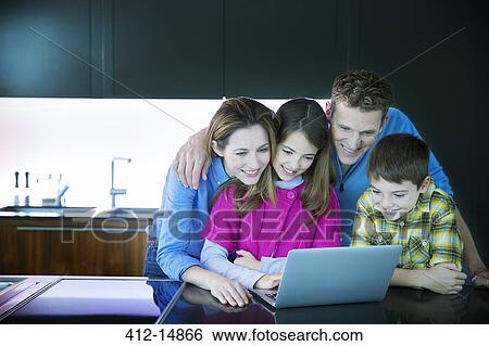 Family using laptop in kitchen View Large Photo Image Stock Photograph - Family using laptop in kitchen. Fotosearch
