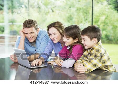 Stock Photo - Family using laptop together. Fotosearch
