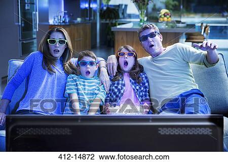 Family watching 3D television in living room View Large Photo Image Stock Image - Family watching 3D television in living room. Fotosearch