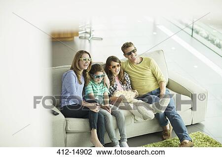 Family watching 3D television in living room View Large Photo Image Stock Image - Family watching 3D television in living room. Fotosearch