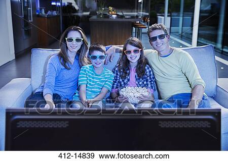 Family watching 3D television in living room View Large Photo Image Stock Photo - Family watching 3D television in living room. Fotosearch