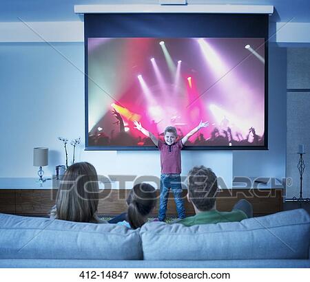 Family watching boy perform in front of concert screen View Large Photo Image Stock Photo - Family watching boy perform in front of concert screen. Fotosearch