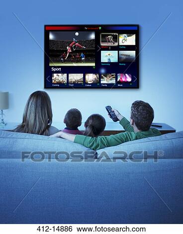Family watching television in living room View Large Photo Image Stock Photograph - Family watching television in living room. Fotosearch