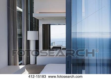Glass door and windows of modern house overlooking ocean View Large Photo Image Stock Image - Glass door and windows of modern house overlooking ocean. Fotosearch