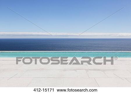 Stock Image - Infinity pool overlooking ocean. Fotosearch