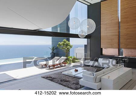 Living room and patio of modern house overlooking ocean View Large Photo Image Stock Image - Living room and patio of modern house overlooking ocean. Fotosearch