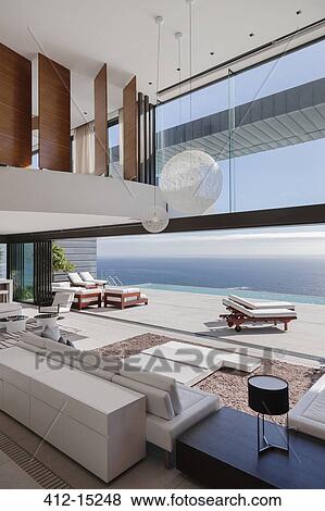 Living room in modern house overlooking ocean View Large Photo Image Stock Photo - Living room in modern house overlooking ocean. Fotosearch