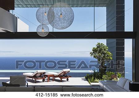Lounge chairs on balcony overlooking ocean View Large Photo Image Stock Photography - Lounge chairs on balcony overlooking ocean. Fotosearch