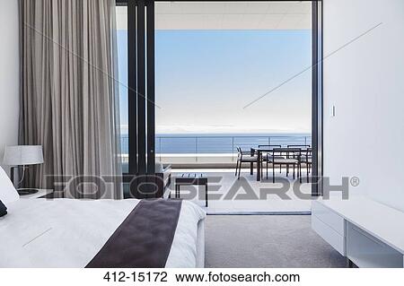 Modern bedroom and balcony overlooking ocean View Large Photo Image Stock Image - Modern bedroom and balcony overlooking ocean. Fotosearch