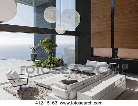 Stock Image - Modern living room overlooking ocean. Fotosearch