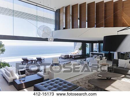 Stock Image - Modern living room overlooking ocean. Fotosearch