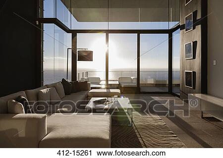 Stock Image - Modern living room overlooking ocean. Fotosearch