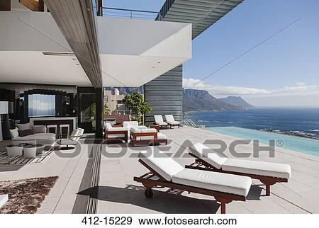 Modern patio and infinity pool overlooking ocean View Large Photo Image Stock Photo - Modern patio and infinity pool overlooking ocean. Fotosearch