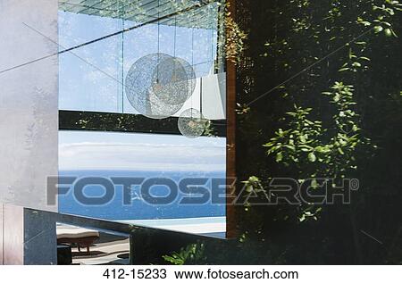 Stock Image - Reflection on window overlooking ocean. Fotosearch