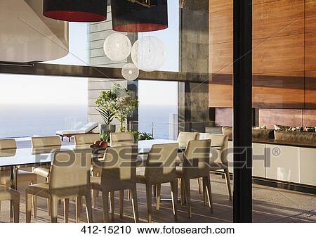 Table and chairs in modern dining room overlooking ocean View Large Photo Image Stock Image - Table and chairs in modern dining room overlooking ocean. Fotosearch