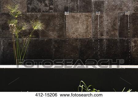 Stock Photograph - Water feature in stone wall. Fotosearch