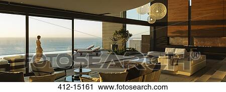 Woman walking on modern patio overlooking ocean View Large Photo Image Stock Image - Woman walking on modern patio overlooking ocean. Fotosearch
