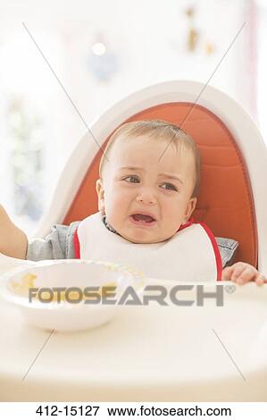 Baby boy crying in high chair View Large Photo Image Stock Photo - Baby boy crying in high chair. Fotosearch
