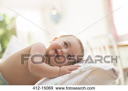 Baby boy leaning on pillow View Large Photo Image Stock Photo - Baby boy leaning on pillow. Fotosearch