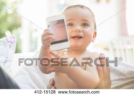 Baby boy playing with cell phone View Large Photo Image Stock Photo - Baby boy playing with cell phone. Fotosearch