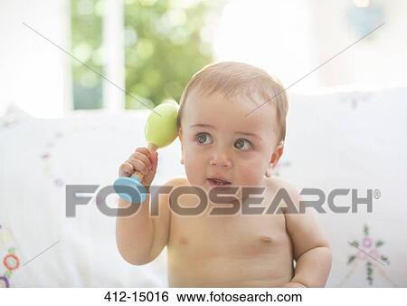 Stock Photograph - Baby boy playing with toy. Fotosearch