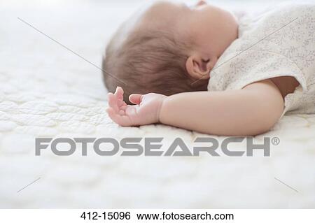 Baby girl laying on bed View Large Photo Image Stock Photograph - Baby girl laying on bed. Fotosearch