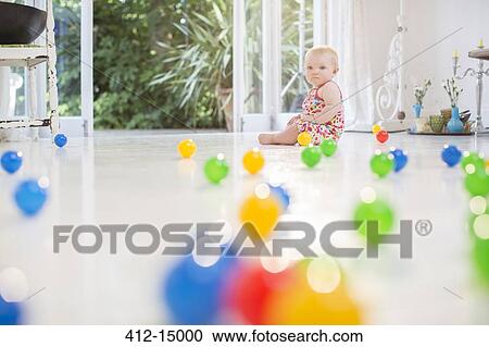 Baby girl with toys on kitchen floor View Large Photo Image Stock Image - Baby girl with toys on kitchen floor. Fotosearch