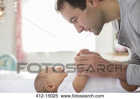 Stock Photography - Father adoring baby boy. Fotosearch