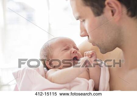Father comforting crying baby girl View Large Photo Image Stock Photography - Father comforting crying baby girl. Fotosearch